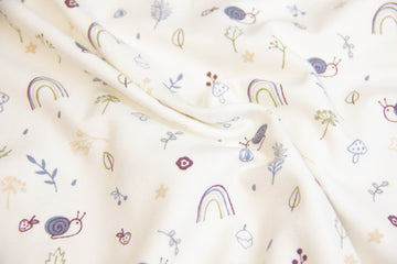 Jersey mit Schnecken und Regenbogen, ecru, 0,5 m